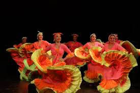 Colombian Salsa and Cumbia dancers performing on colorful stage